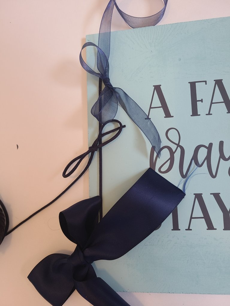 three navy bows with different ribbon types to put on the Dollar Tree Cricut sign