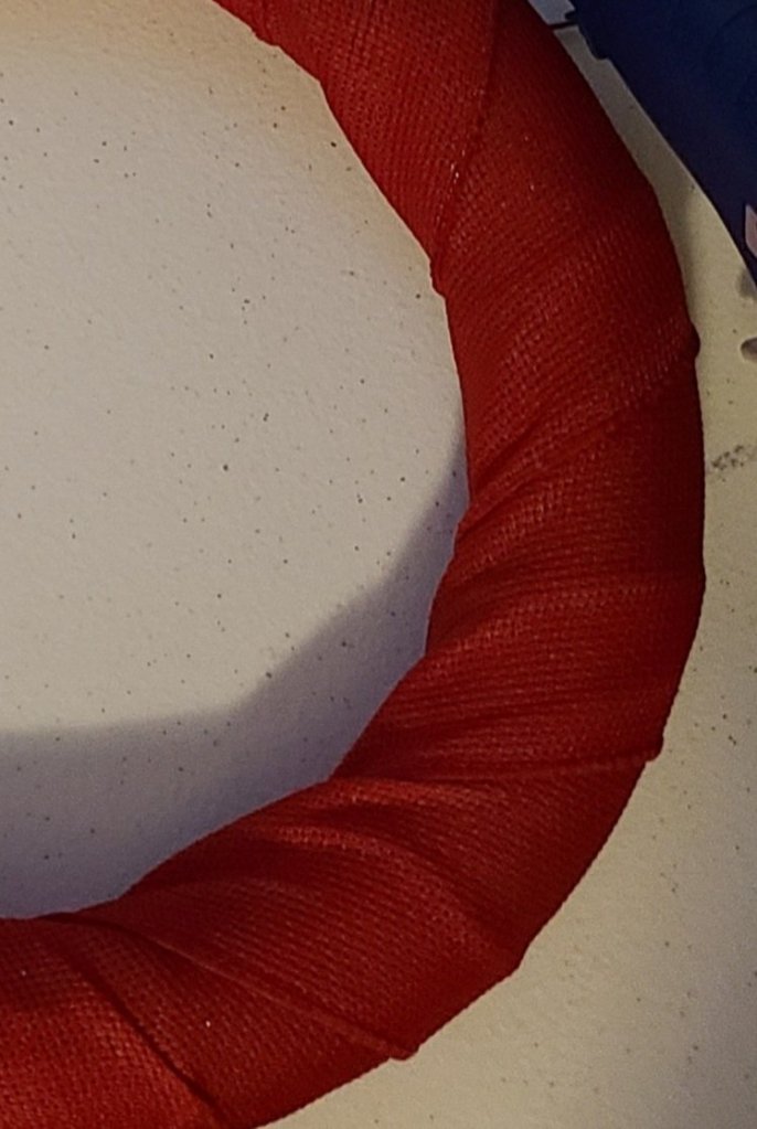 Pleats in the red burlap of the DIY patriotic wreath.