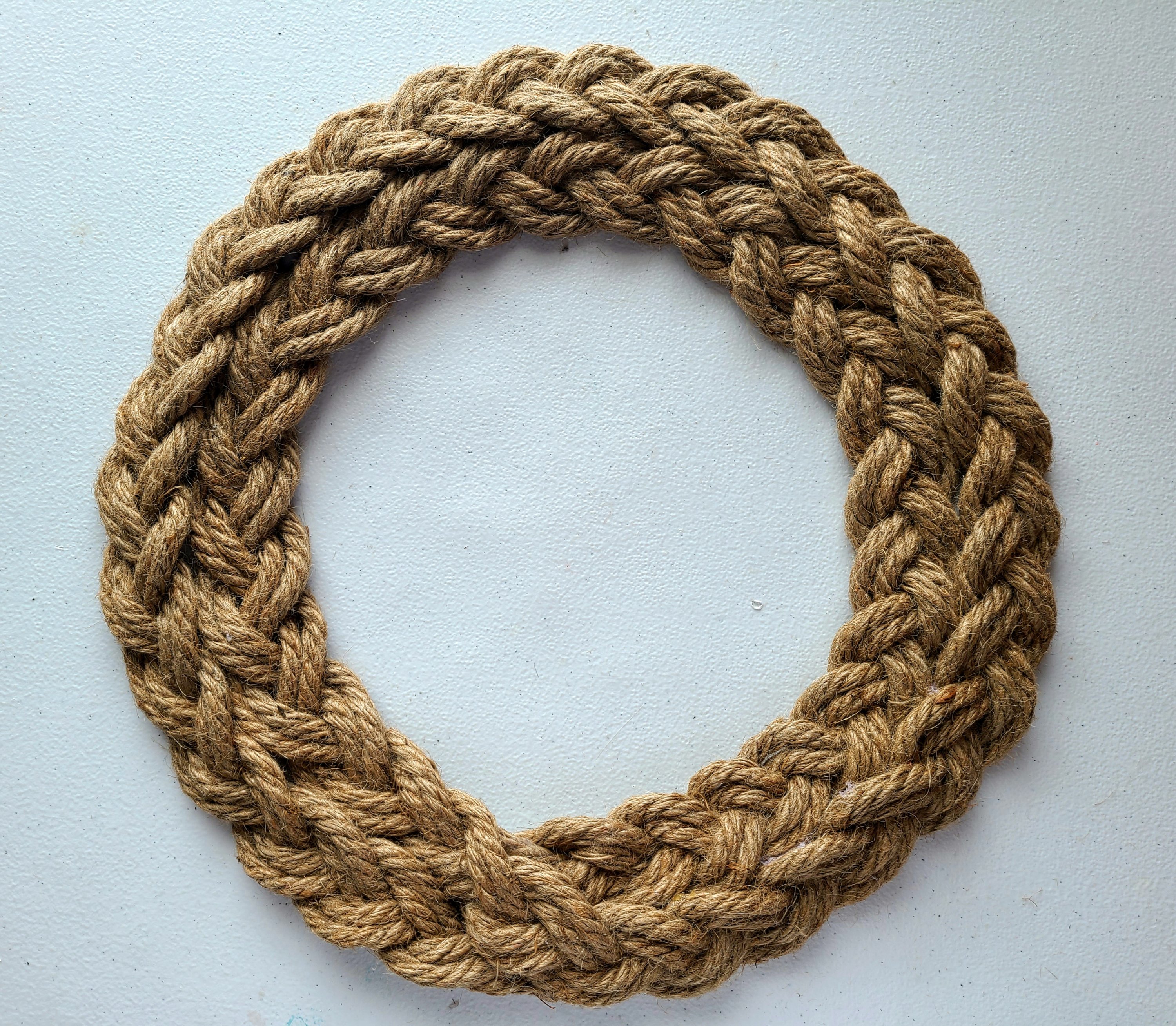 Braided rope completely attached to the wreath form.