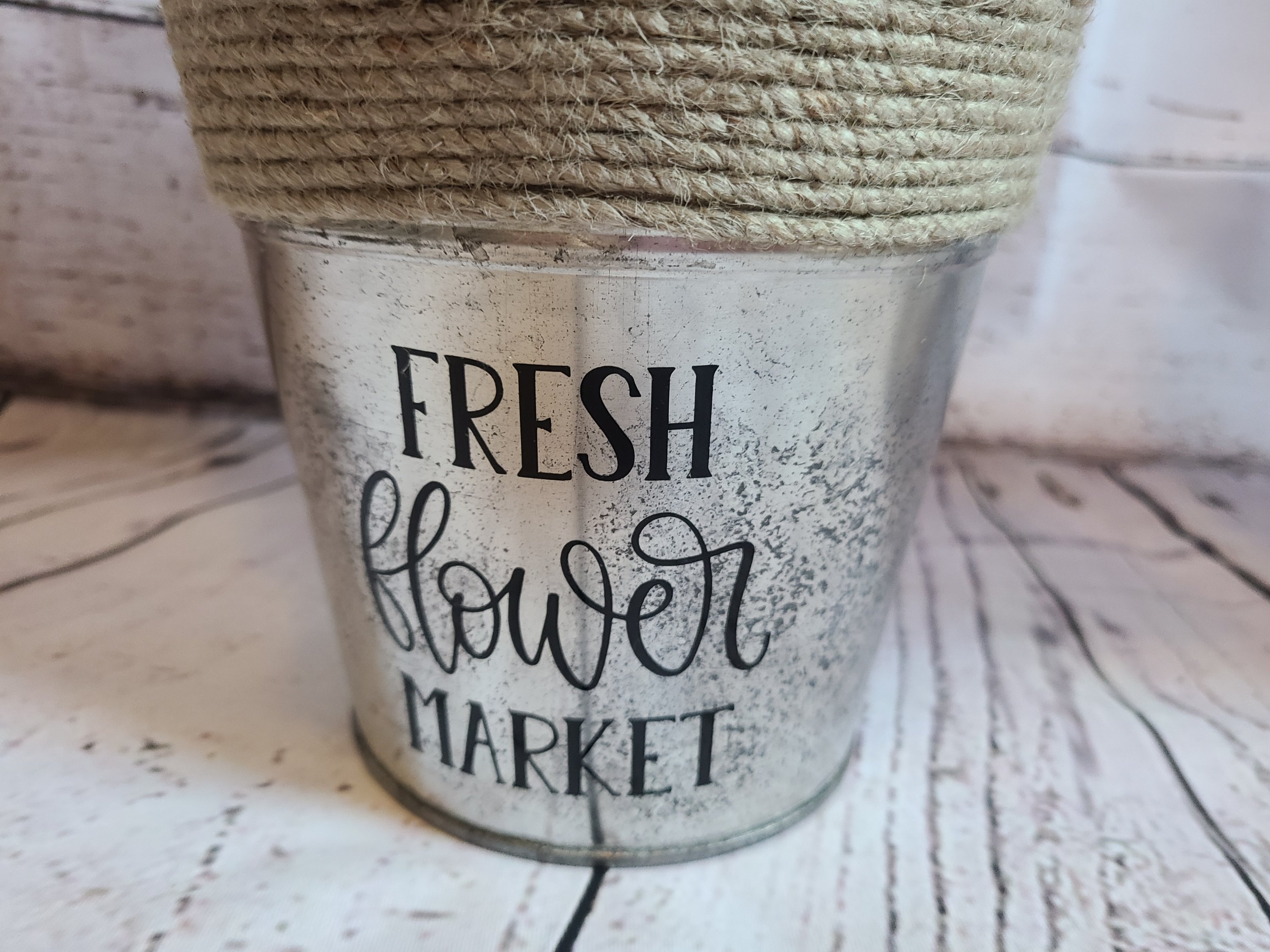 DIY galvanized metal flowerpot with "fresh flower market" on the front which will hold the end of the year teacher gift of flower seed packet, paper flowers, and a free printable gift tag.