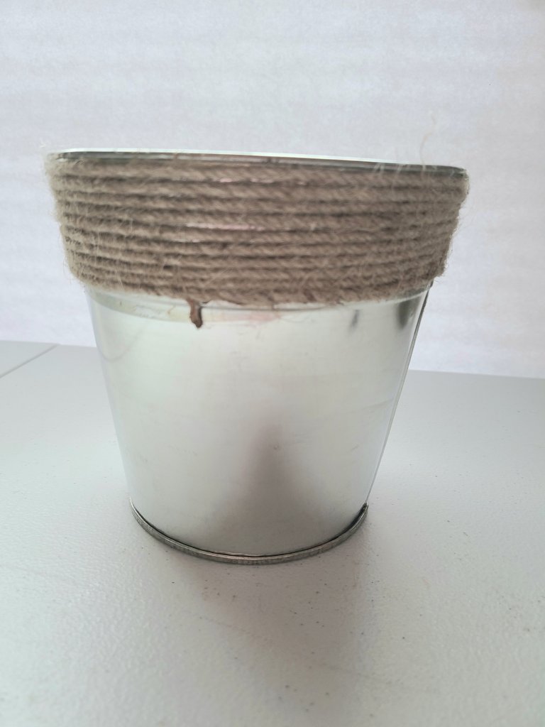 Original metal flower pot with twine top trim that will become a DIY aged metal galvanized flower pot.