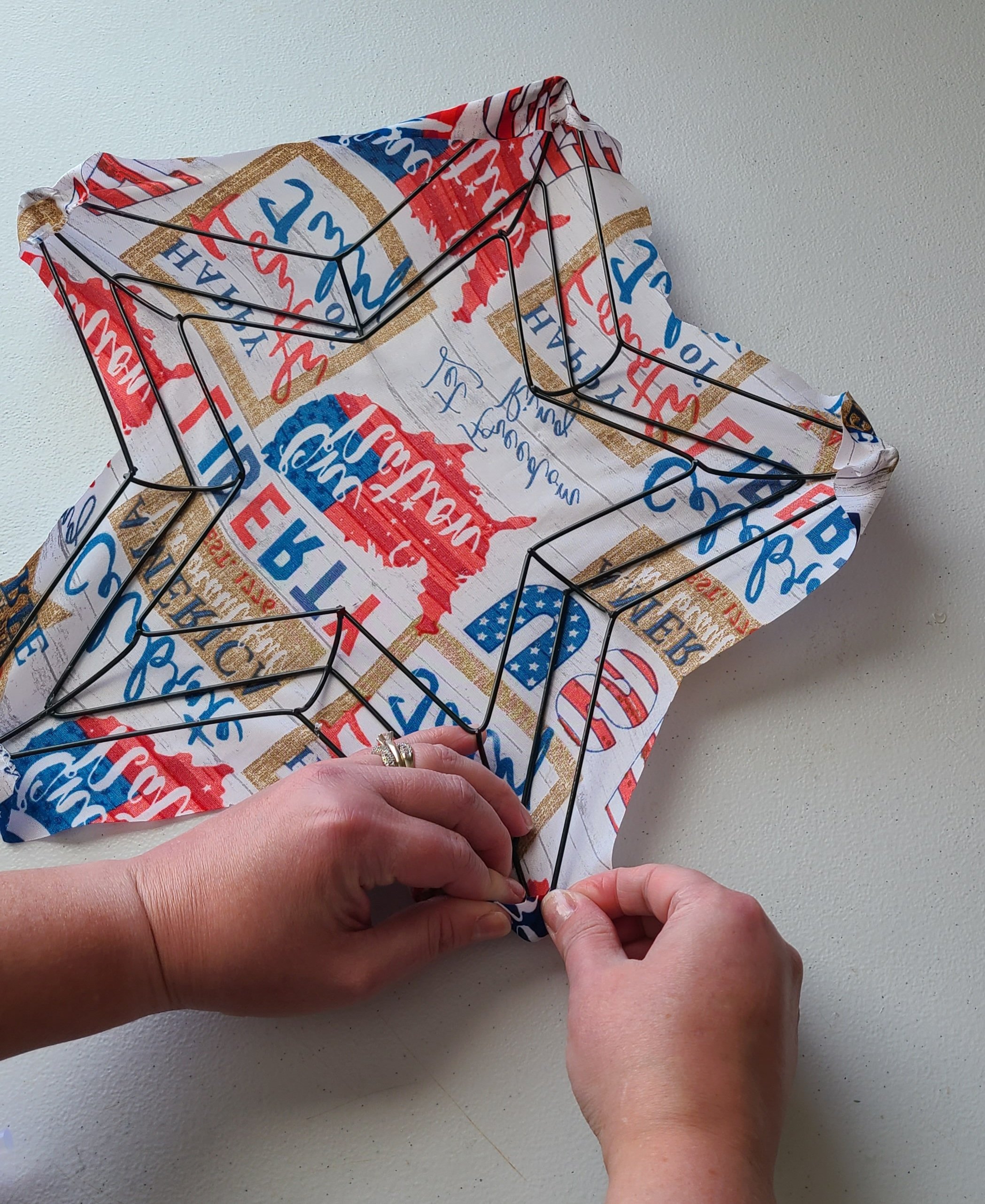 Folding the patriotic bandana over the bottom right tip of the star wreath form.
