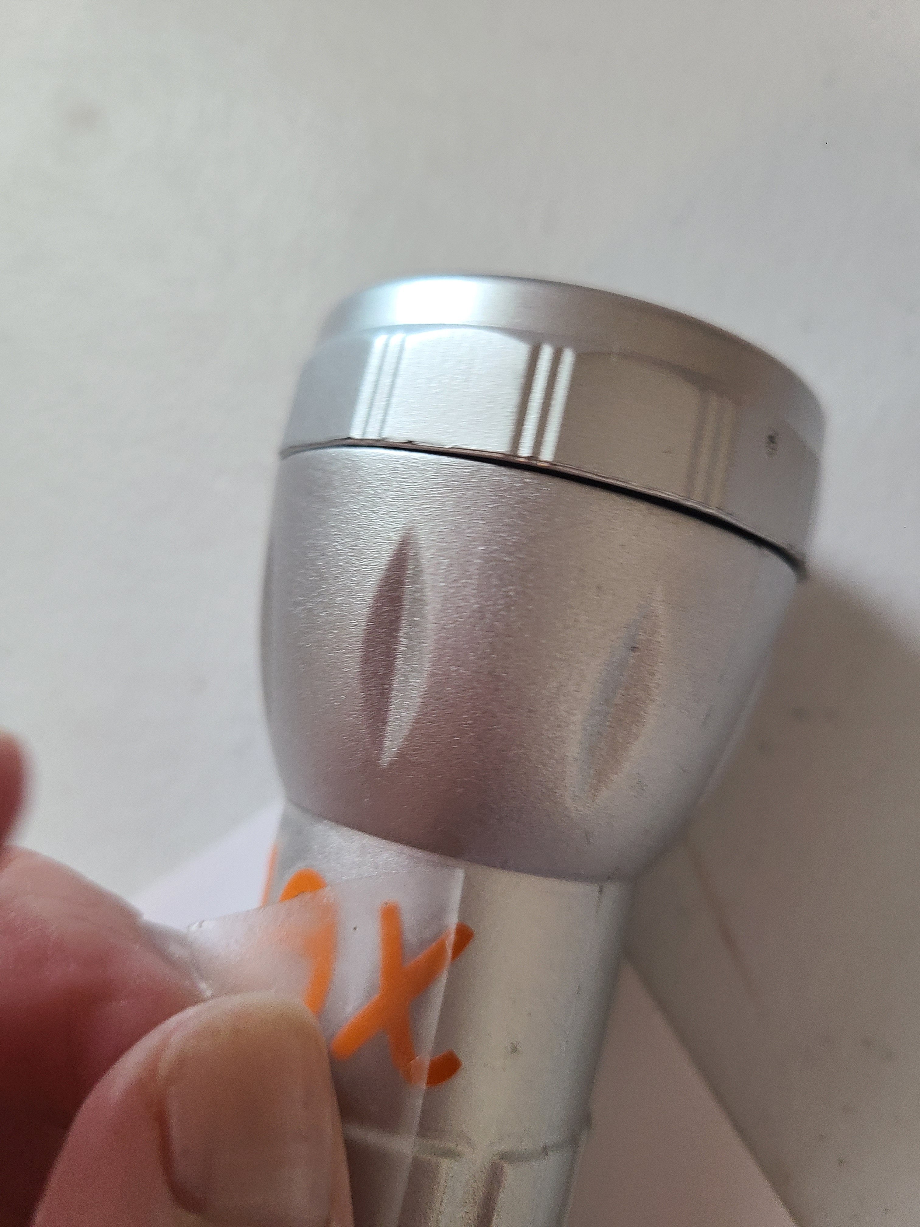 Removing transfer tape from flashlight after transferring a name onto it.