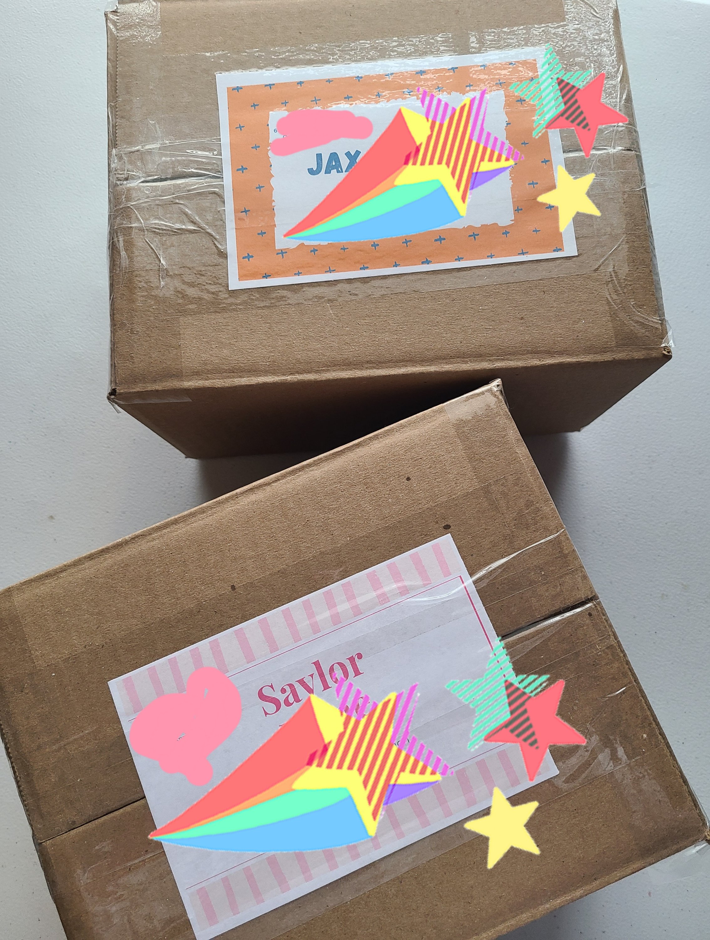 Summer camp care boxes taped up and topped with printed name and address labels.