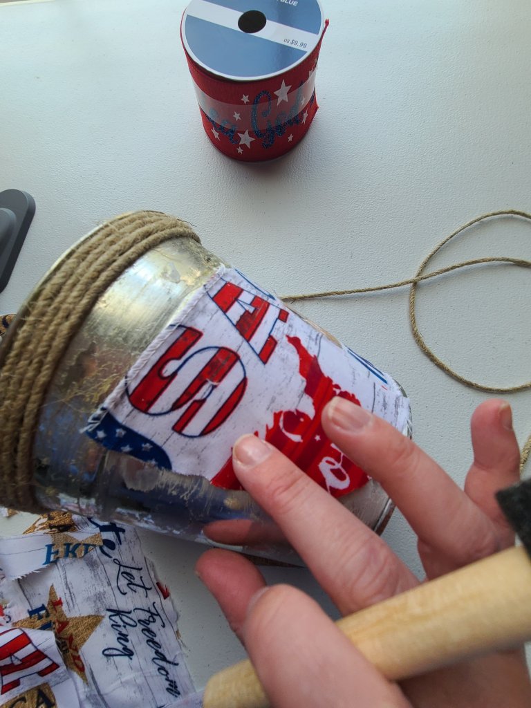 Smooth out any wrinkles or bubbles in the fabric with your finger on your patriotic centerpiece.