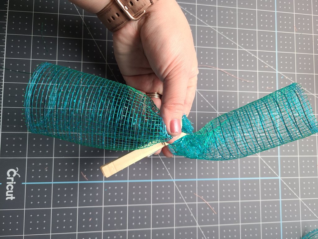 Two spiral rolls of deco mesh held together in the center by a clothes pin. Two are combined to make one of the proper size.