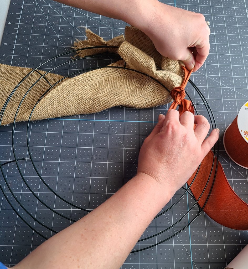 Tie the accent ribbon to the innermost ring on the burlap wreath.