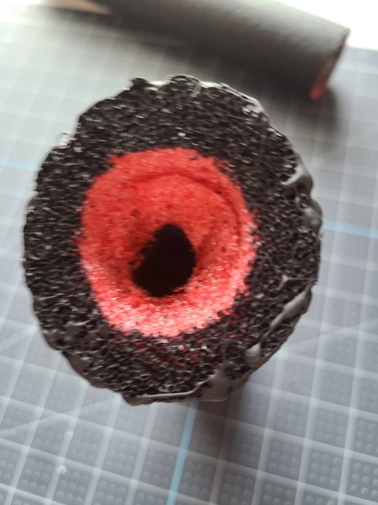 A hole cut for a tealight candle in the top of the faux candle pool noodle.