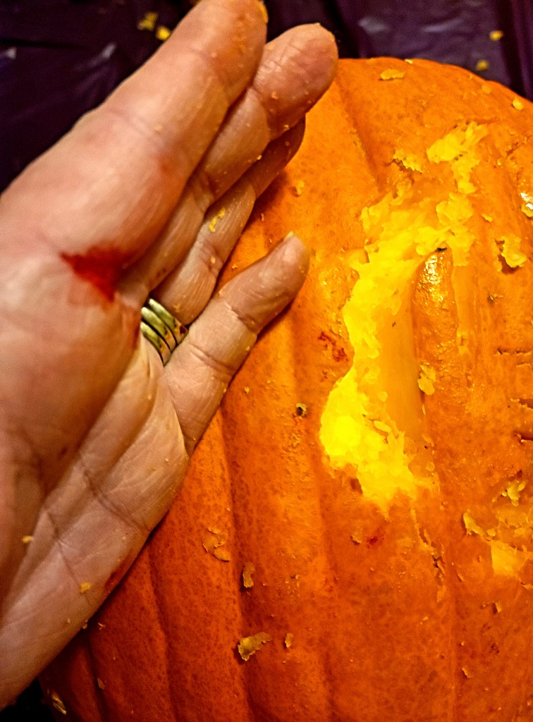 My hand stabbed carving a jack-o-lantern on Halloween family movie night.