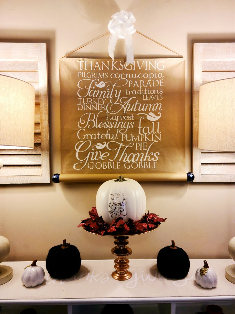 Thanksgiving scroll wall hanging over fall vignette.