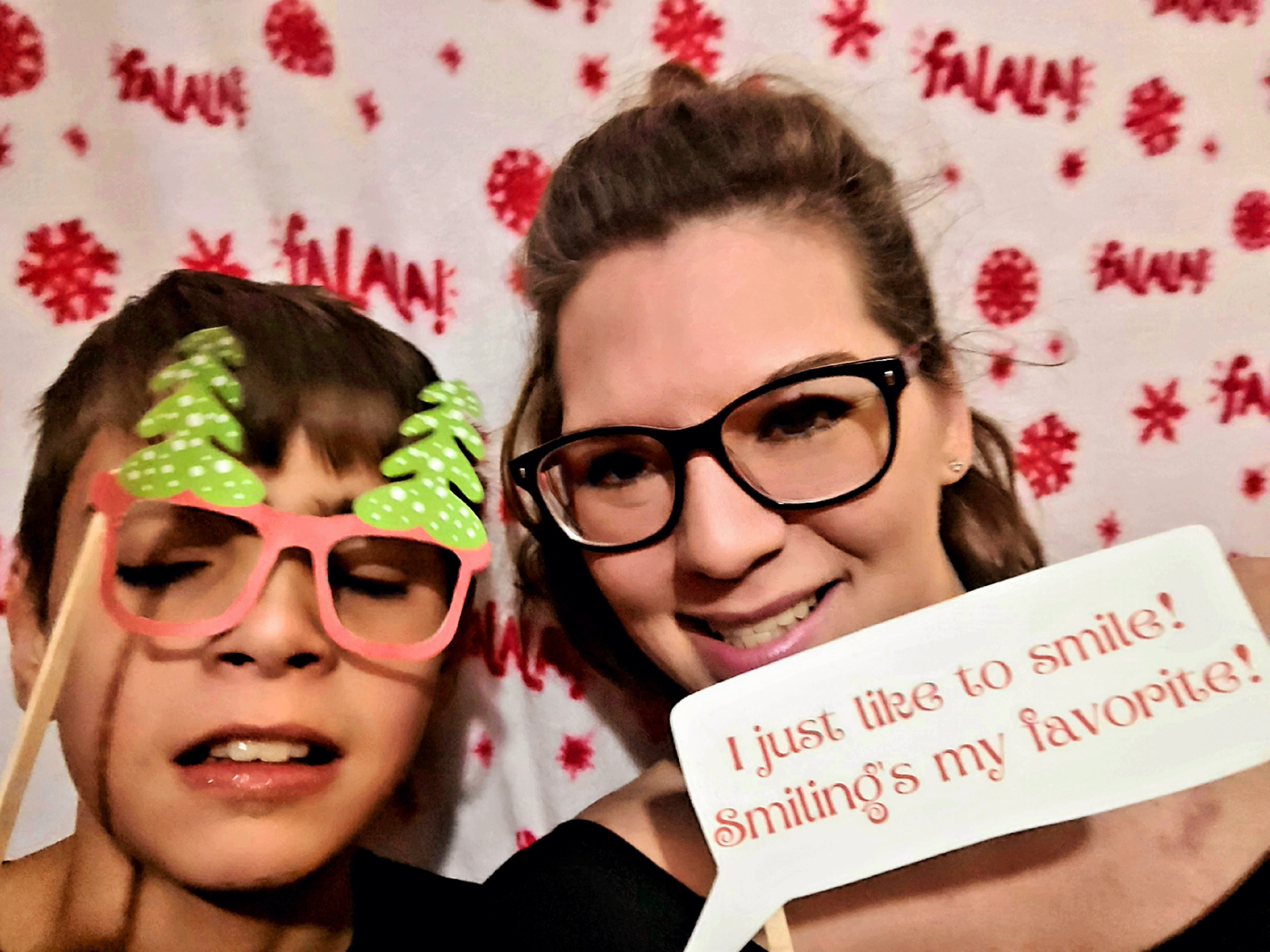 My son and I in the DIY Christmas photobooth set up with a Christmas blanket backdrop on Elf family movie night.