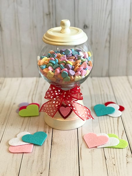 Dollar Tree Valentine's Day decor: a candy dish set made with small round vase and a terra cotta pot to hold Sweethearts.