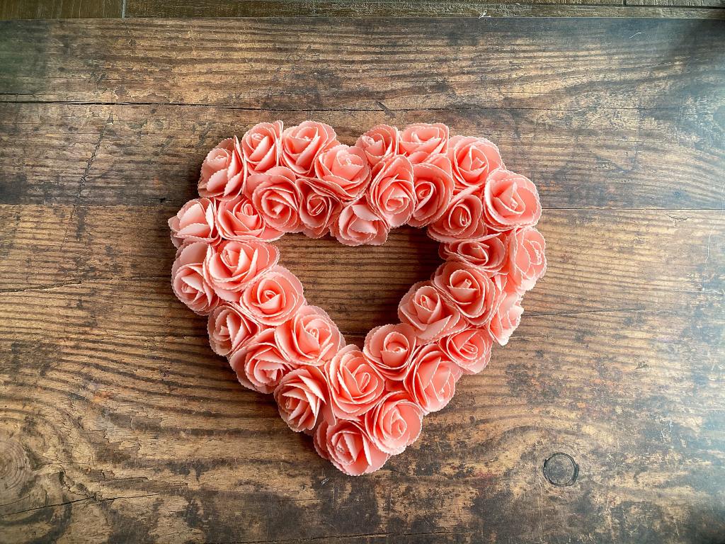 Dollar Tree Valentine's Day decor heart wreath covered in light pink roses.
