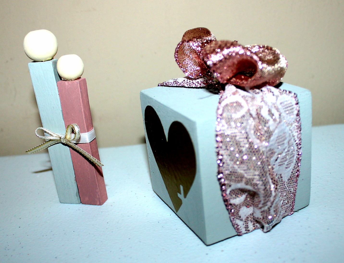 Two pieces of Valentines Day tiered-tray decor. Wood "couple" and box with hearts.