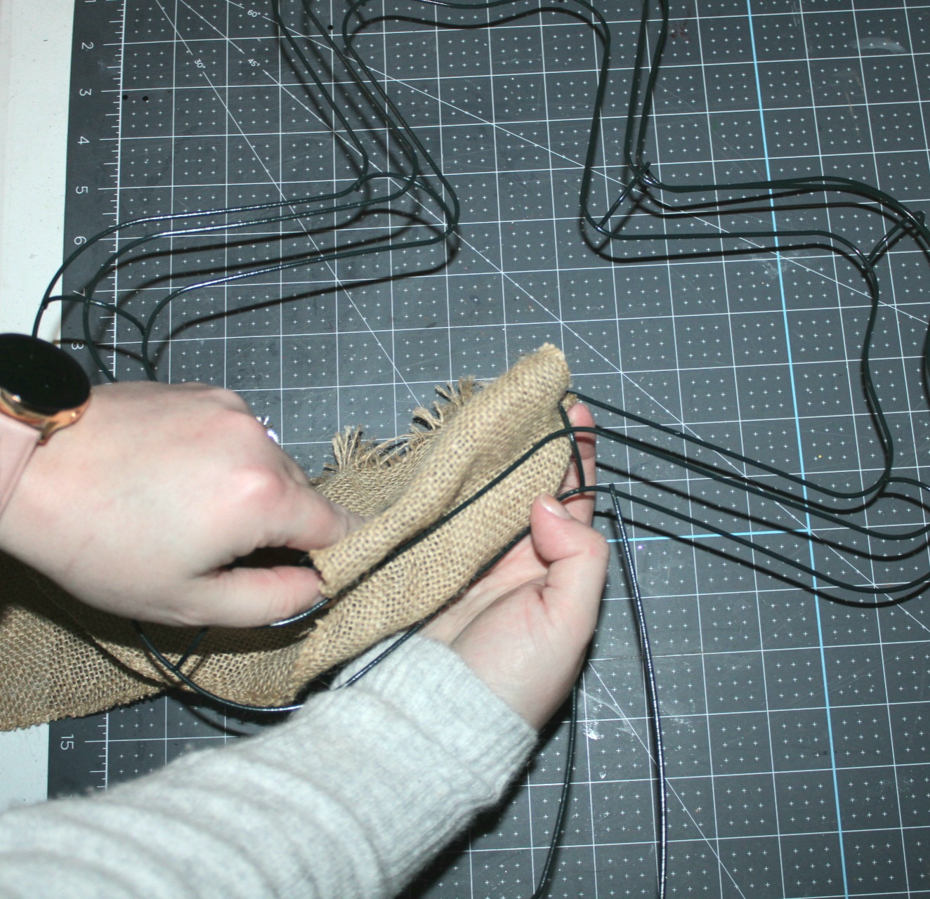 Sliding burlap between the wires on the shamrock wreath form.
