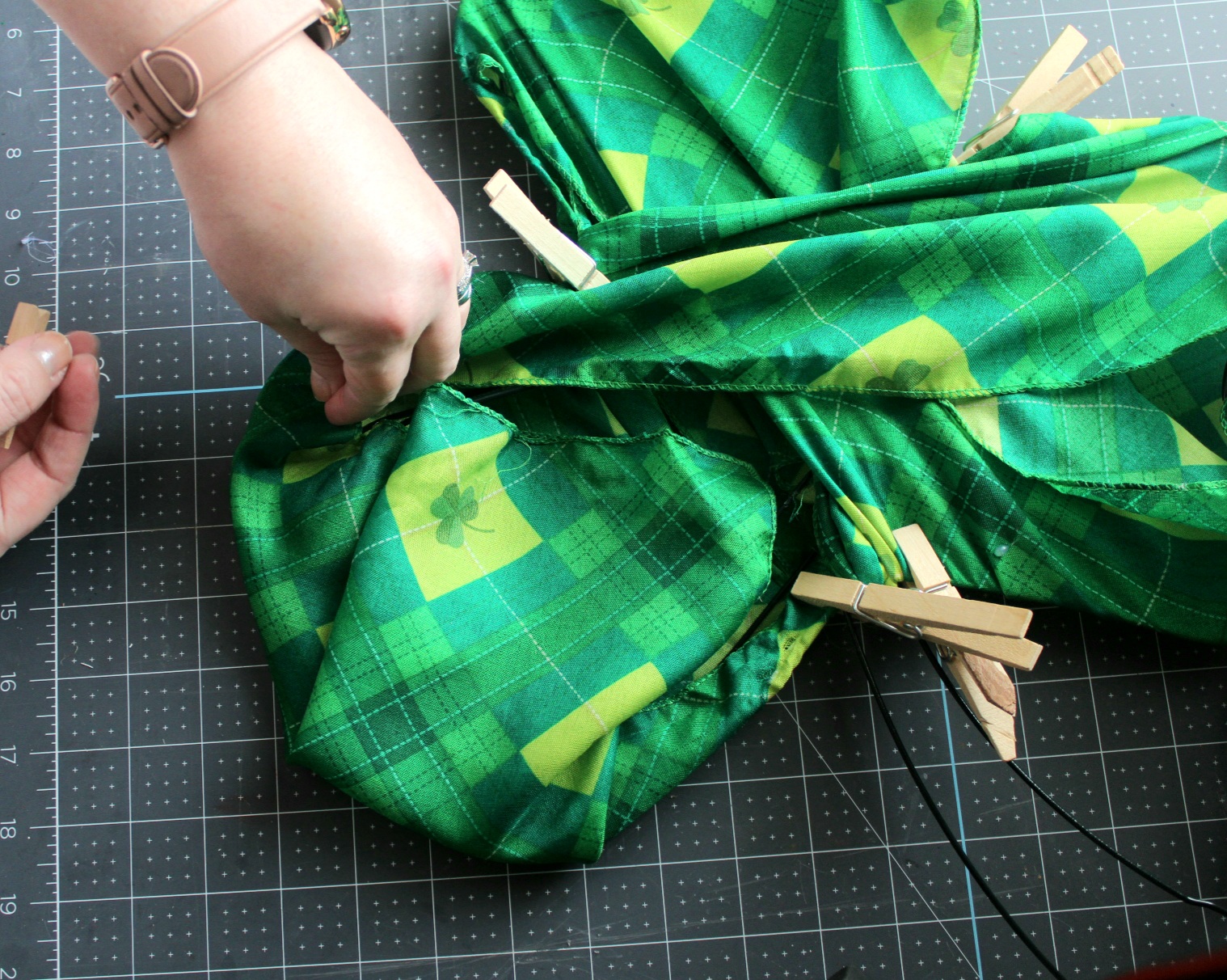 Pinning the scarf in place on the right leaf with clothespins.