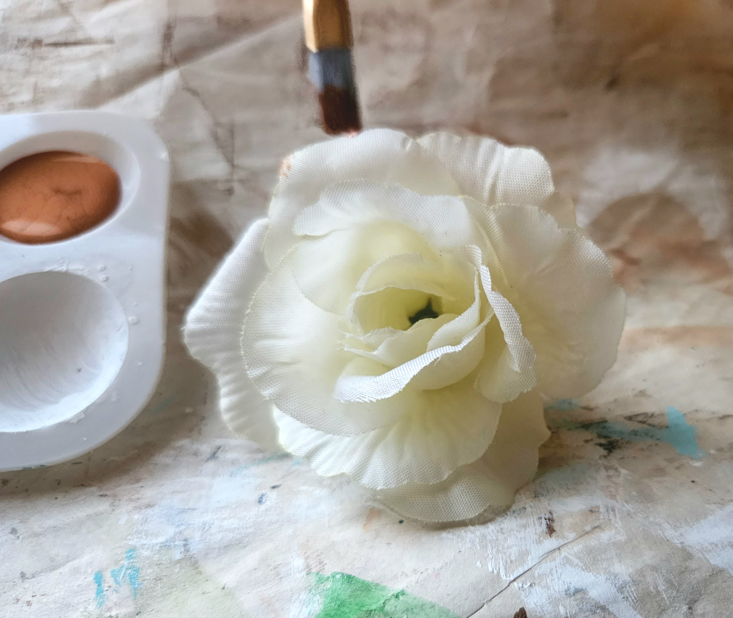 Painting a white faux rose copper.