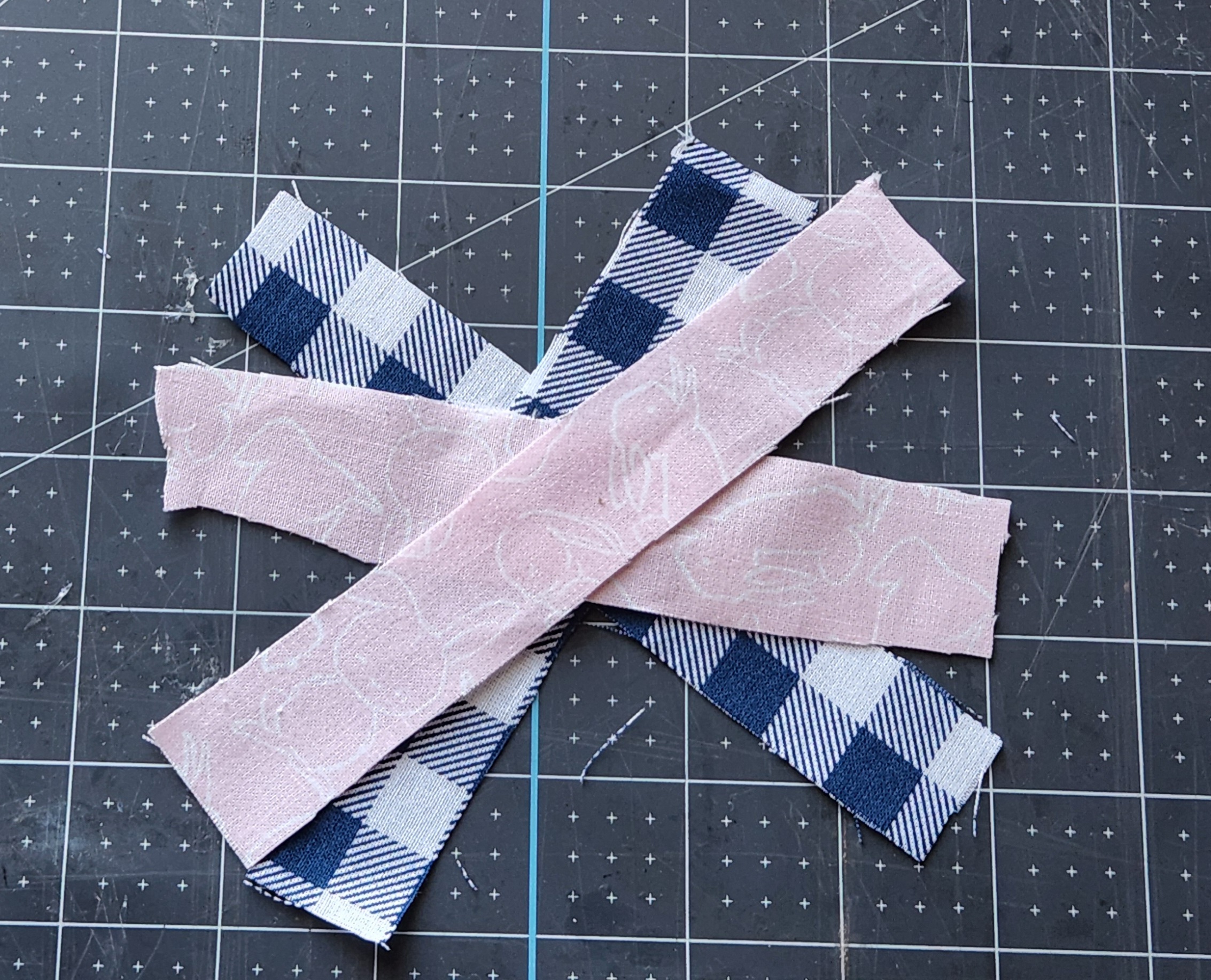 Fabric strips cut in 1x6 pieces crisscrossed to a bow.