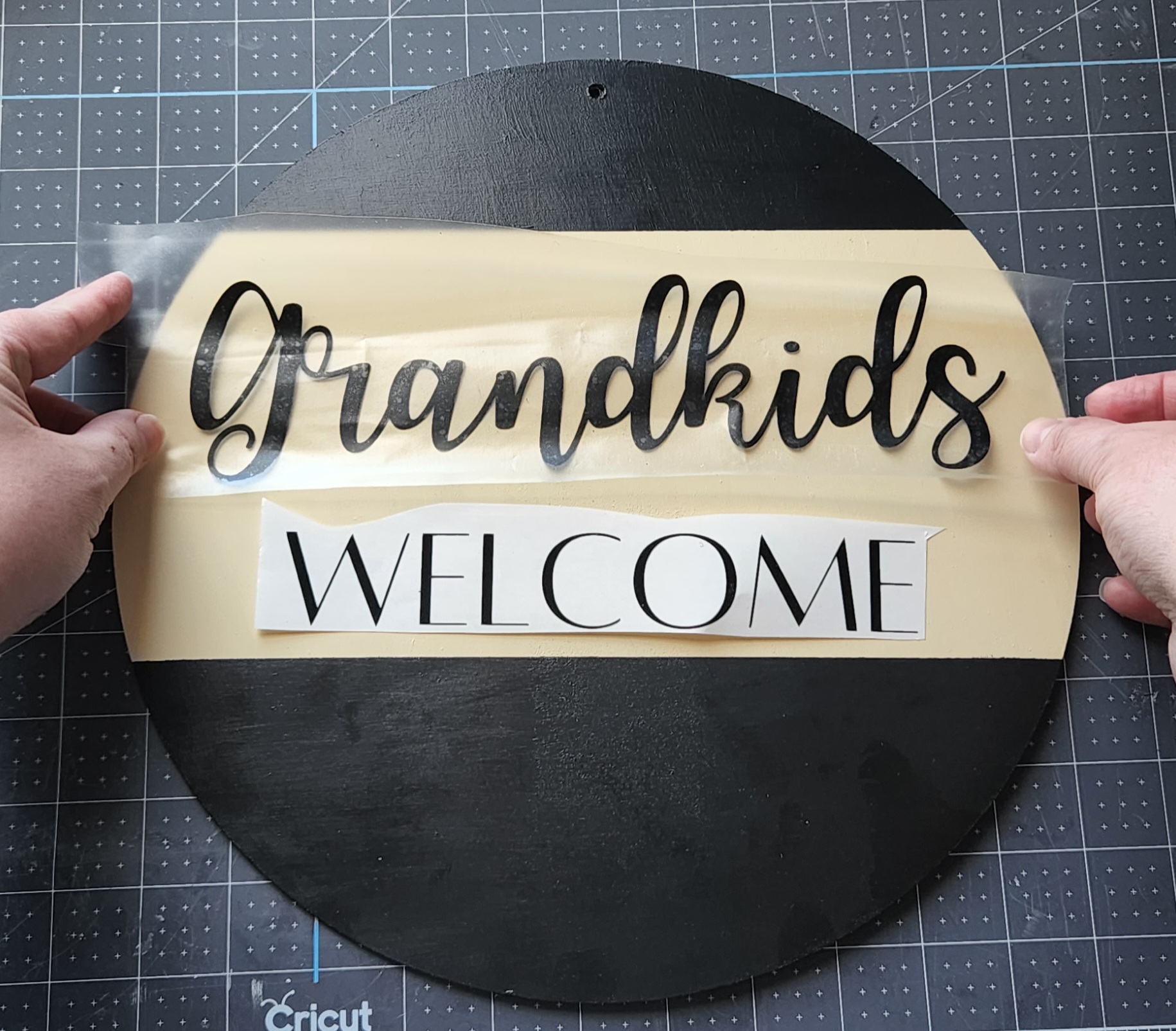 Placing "grandkids" cut in black vinyl on the Mother's Day sign.