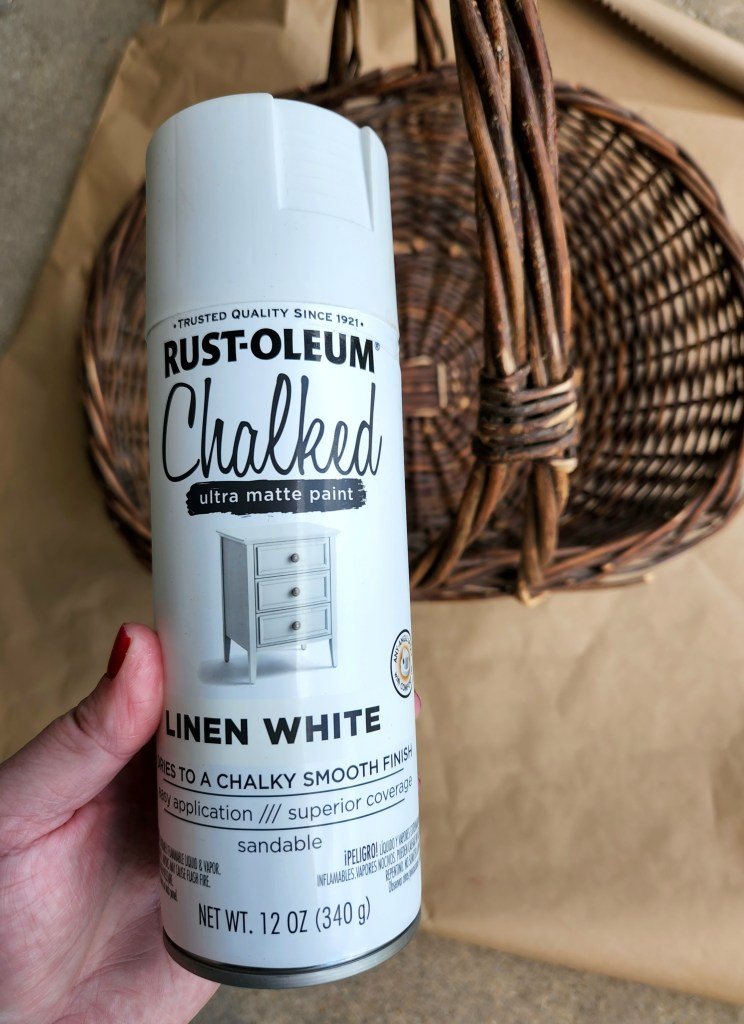 Thrift store upcycle supplies: brown wood basket and Rust-oleum Chalked spray paint in white.