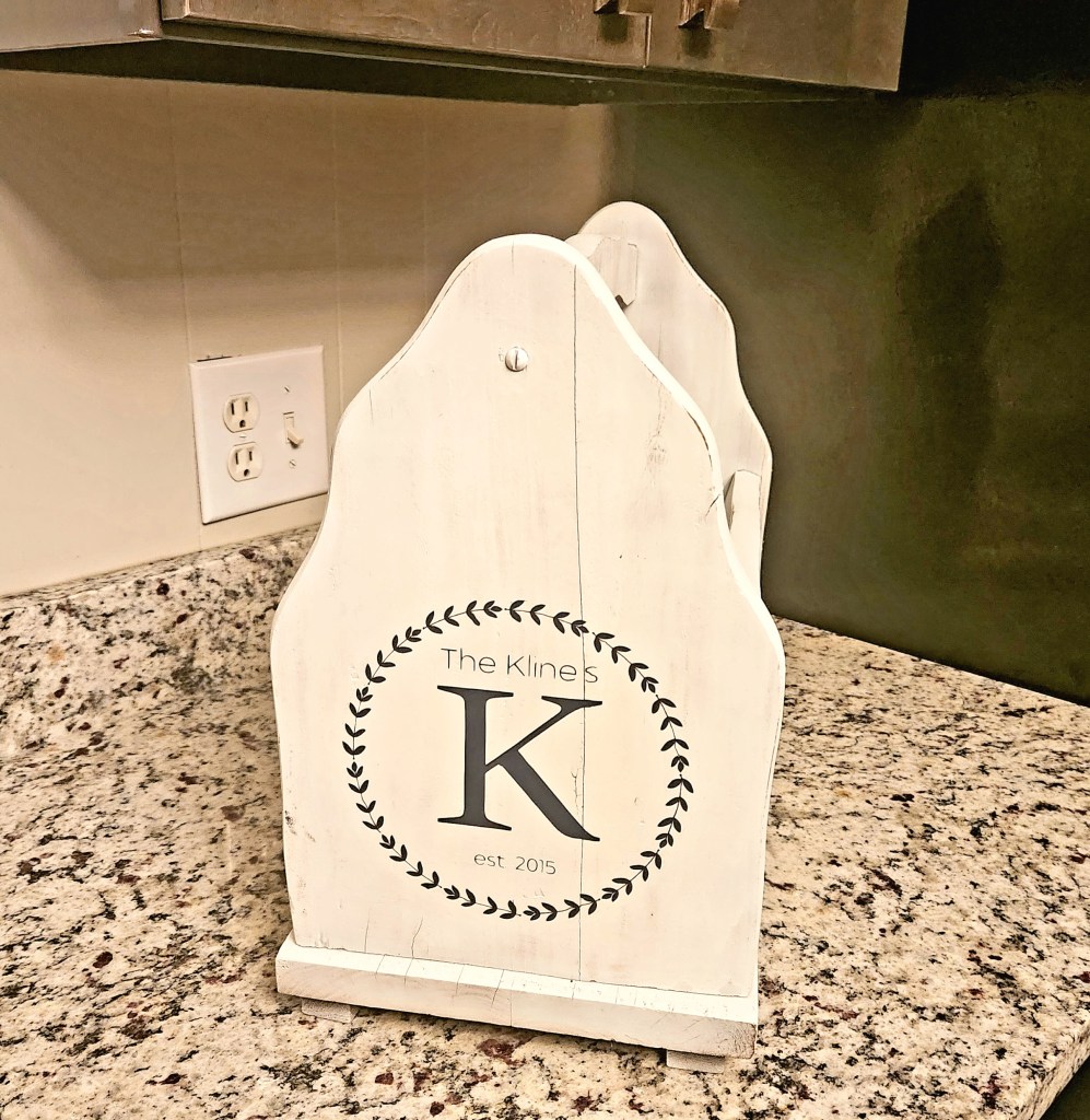 Completed magazine rack with a "K" and the date of our union on the side of it.