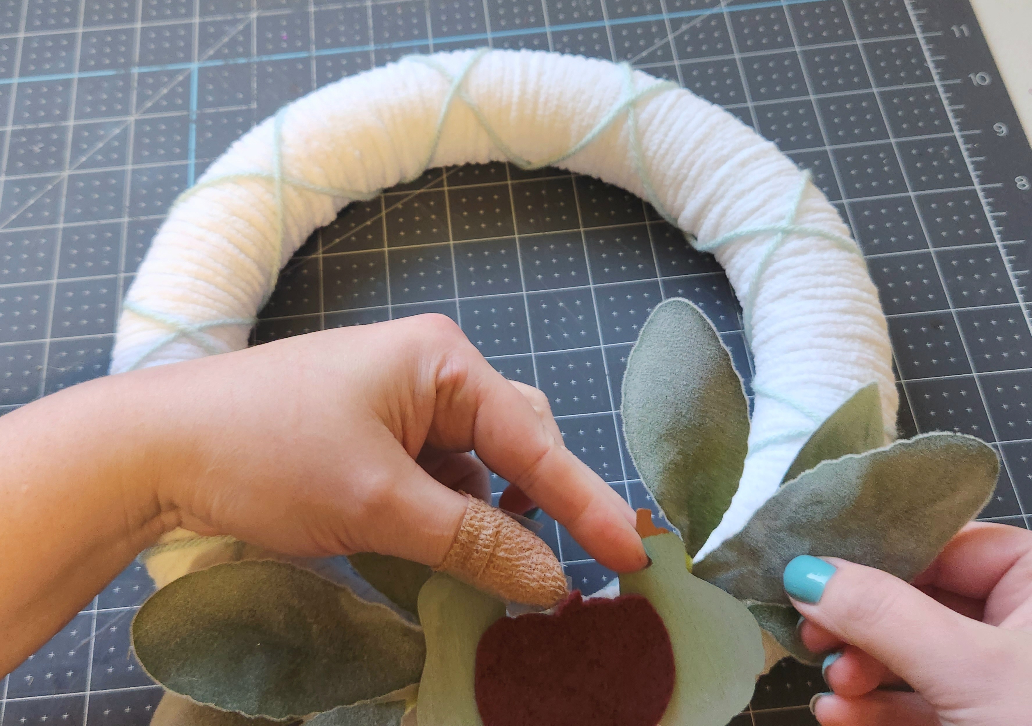 Gluing a lamb's ear leaf over the bare spot between the piece with three leaves.