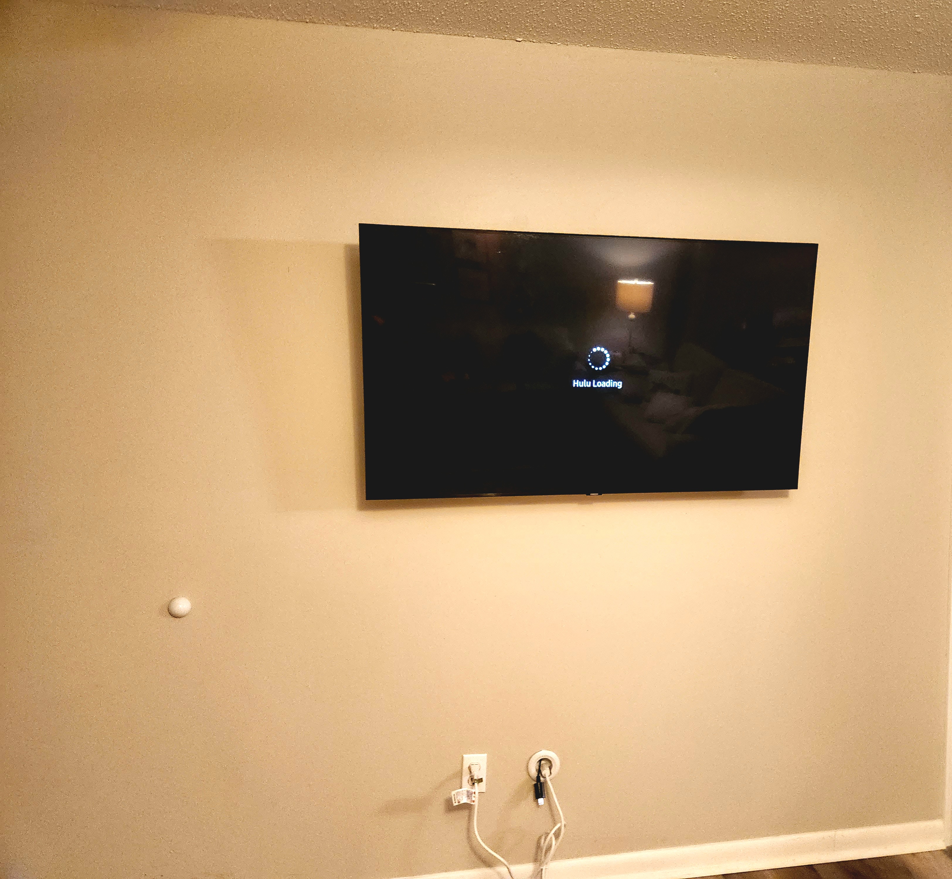 TV mounted on the wall with the cords hidden in the wall.