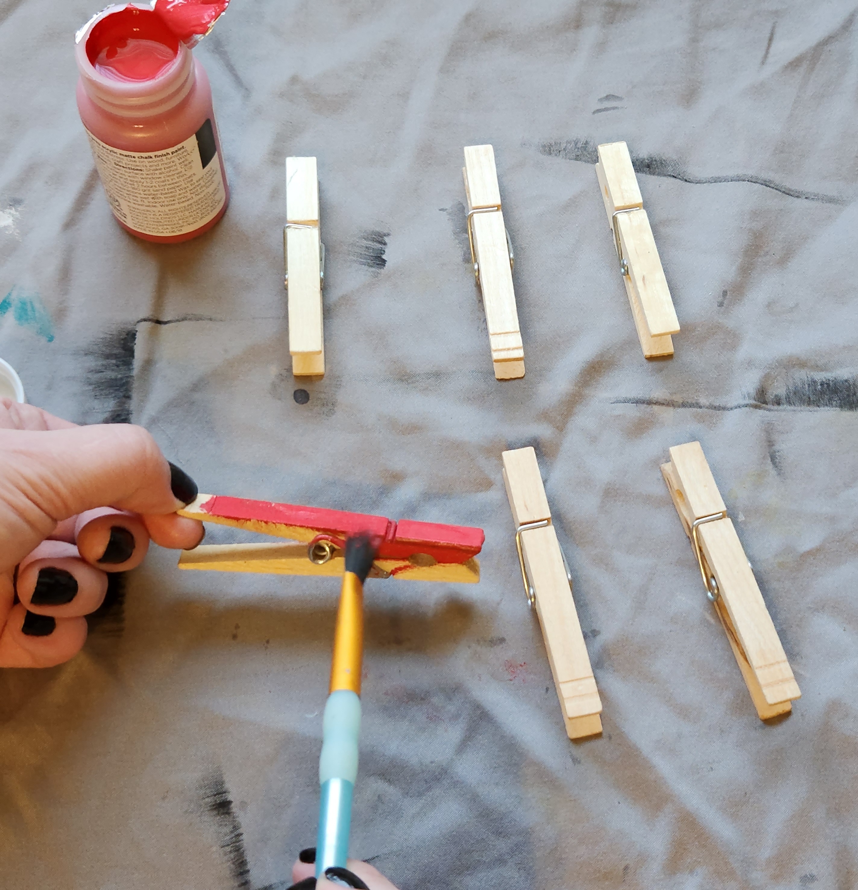 Painting clothes pins with Waverly chalk paint in crimson.