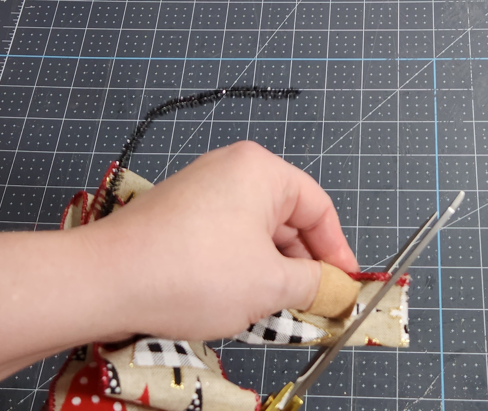 Dovetailing the ends of a six loop bow for the tree topper.