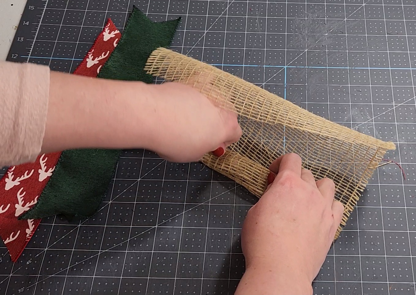 Rolling a piece of deco mesh into a tight spiral.