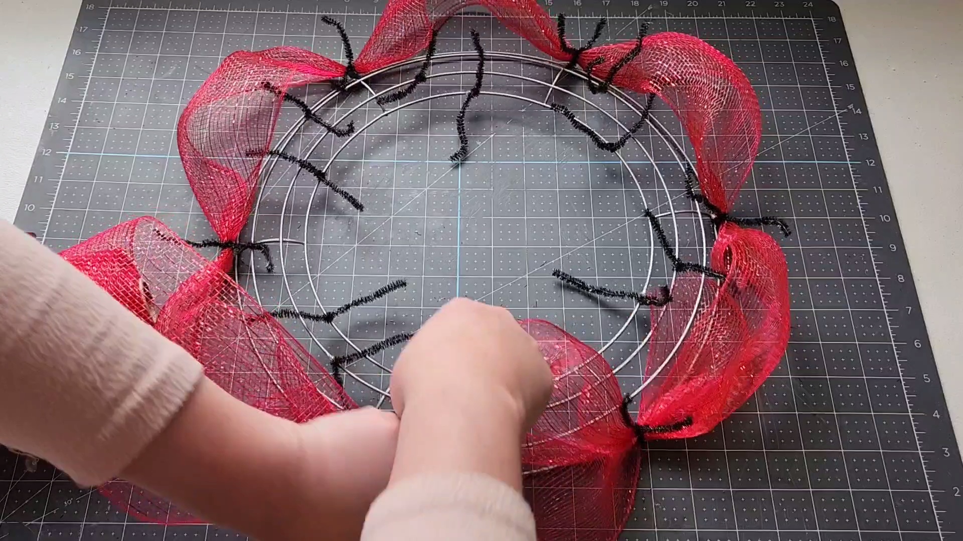 Adding bubbles of deco mesh on the wreath form with the entire outside wire full.
