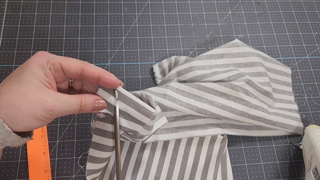 Cutting a triangle on folded fabric.