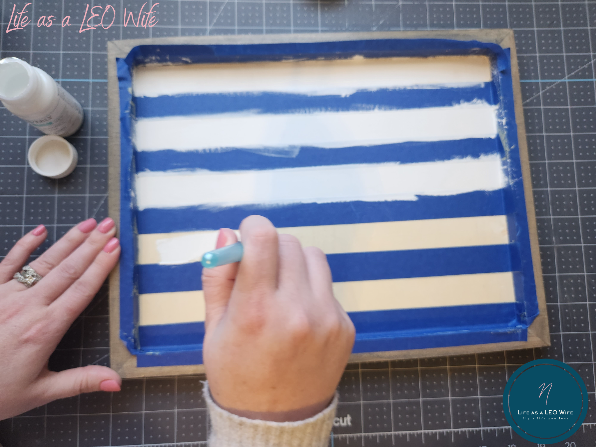 Painting white stripes on the St. Patrick's Day sign.