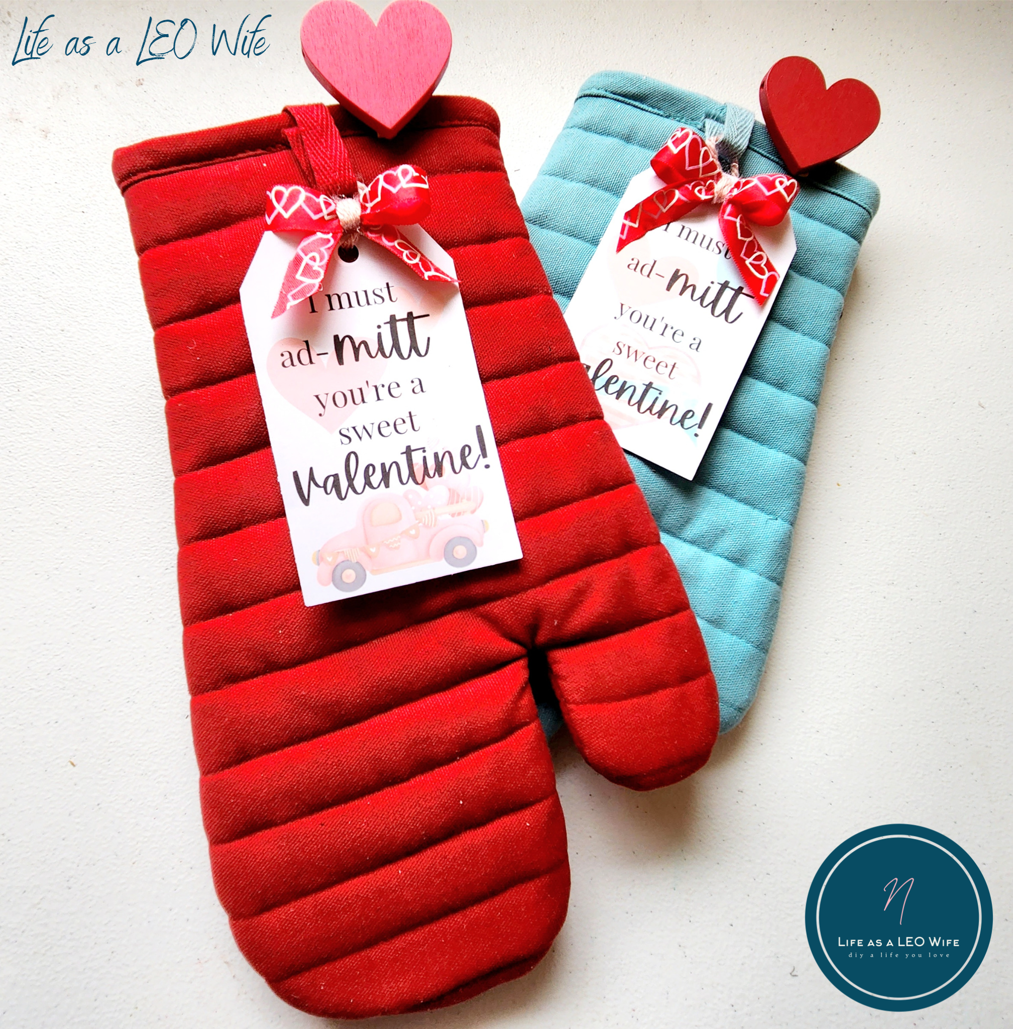 Last minute Valentine's gift for my son's teachers; a blue oven mitt and a red oven mitt with gift tags that say, "I must ad-mitt you're a sweet Valentine!"