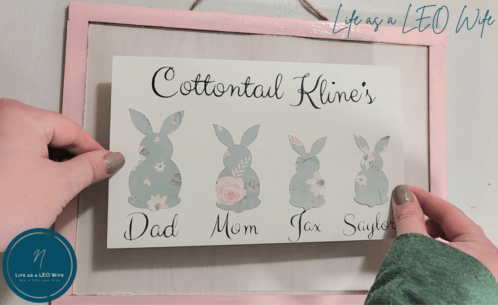 Placing the family bunny sign on the large one.