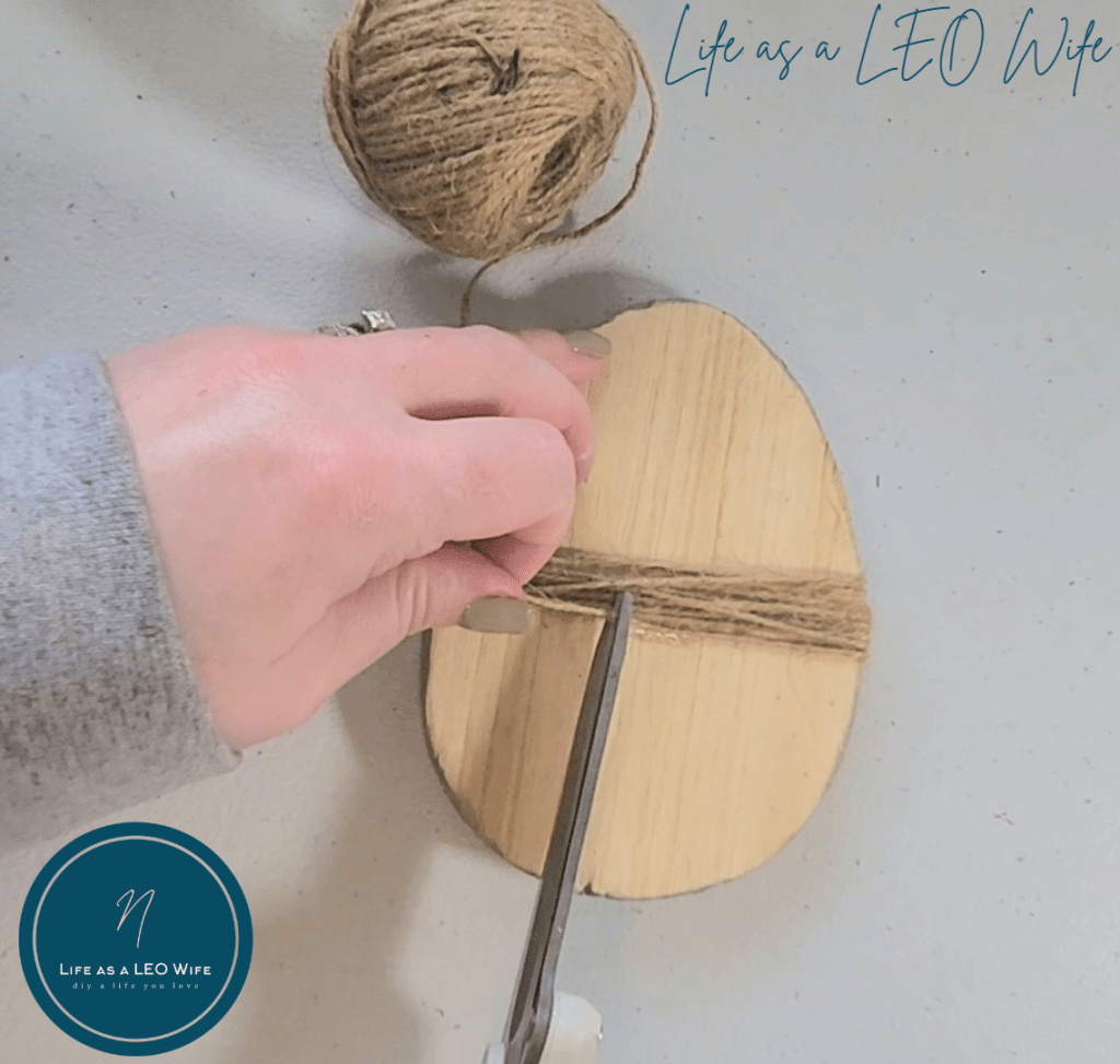 Cutting extra twine off the wood egg.