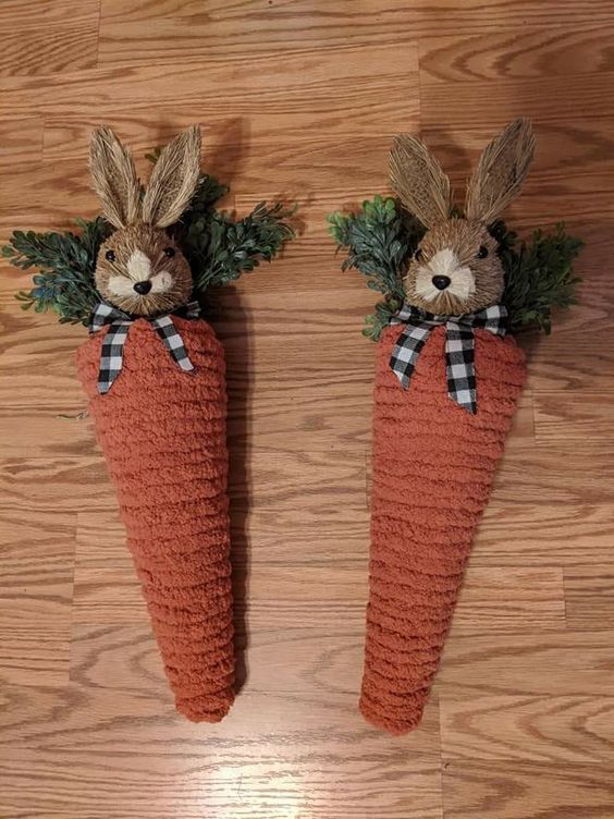 Orange chunky yarn carrots topped with brown bunnies with black and white buffalo check bows for spring decor.