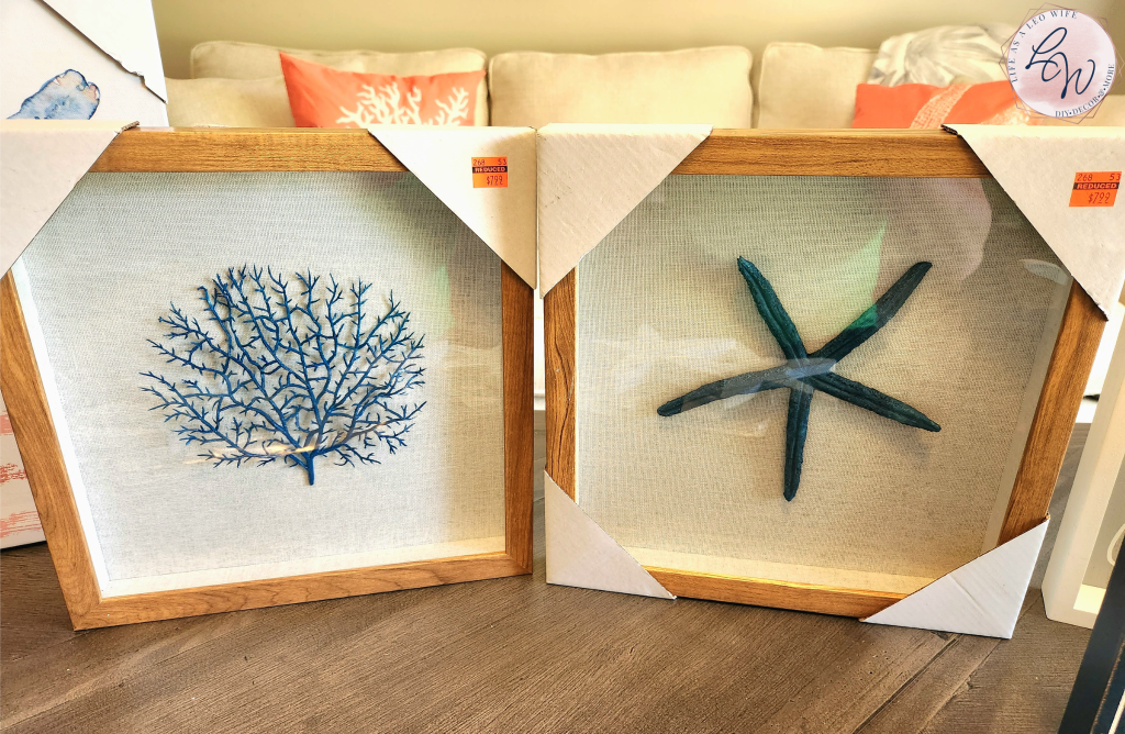 Two coastal shadow box decor frames from Hobby Lobby, one containing a piece of cerulean blue coral and the other the same color starfish mounted on a piece of natural colored linen.