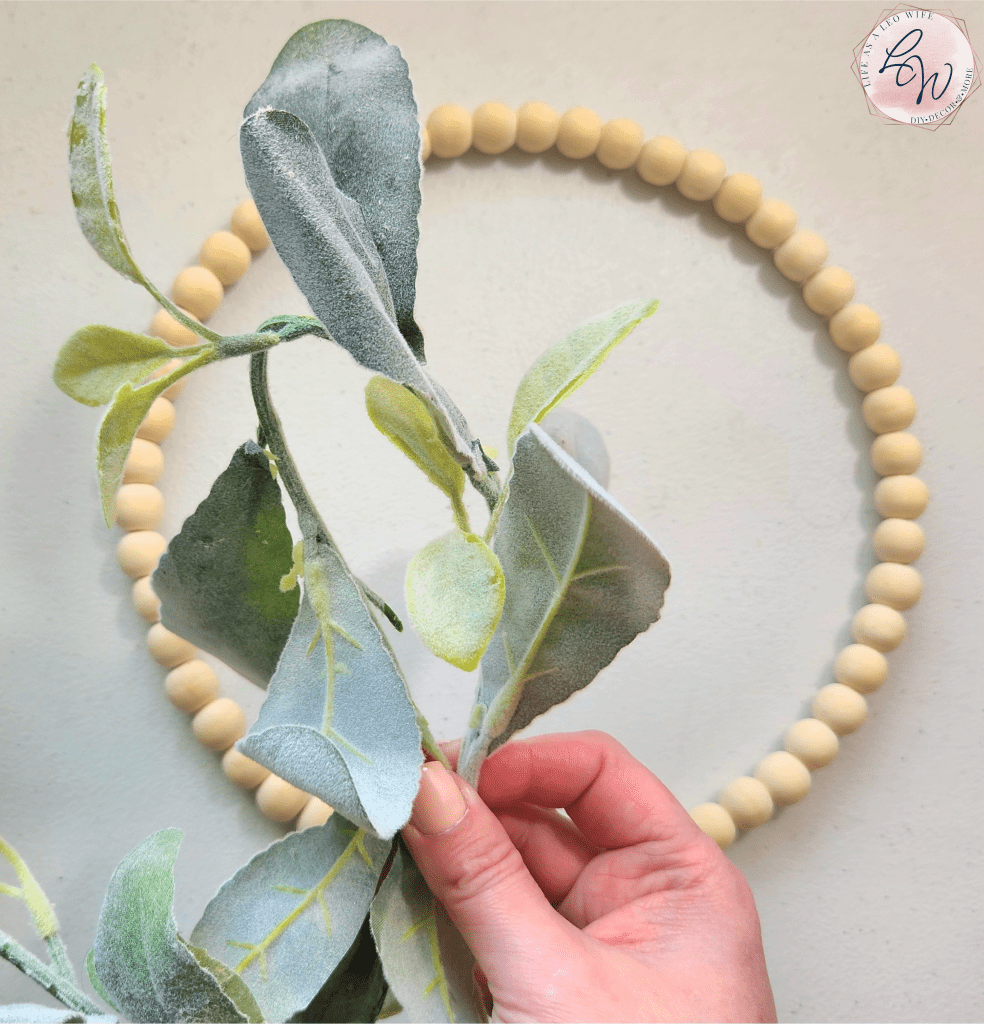 Bending a lamb's ear garland so that it's doubled over.