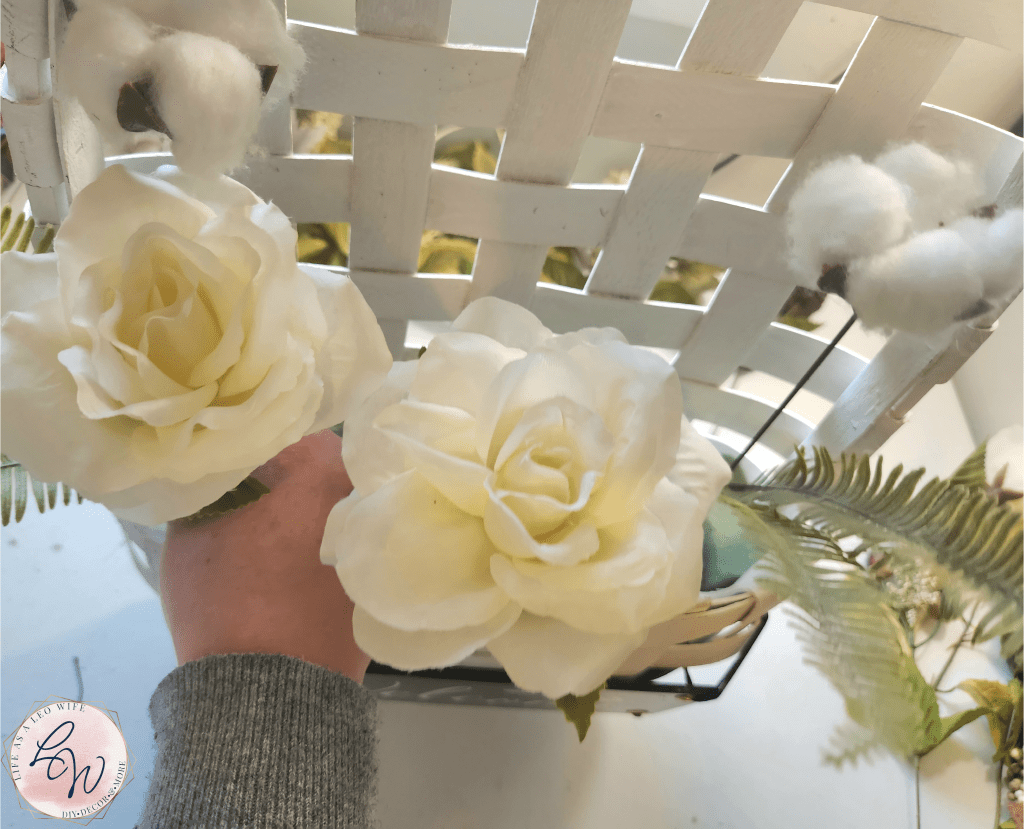 Adding a white rose to the left side of the basket.