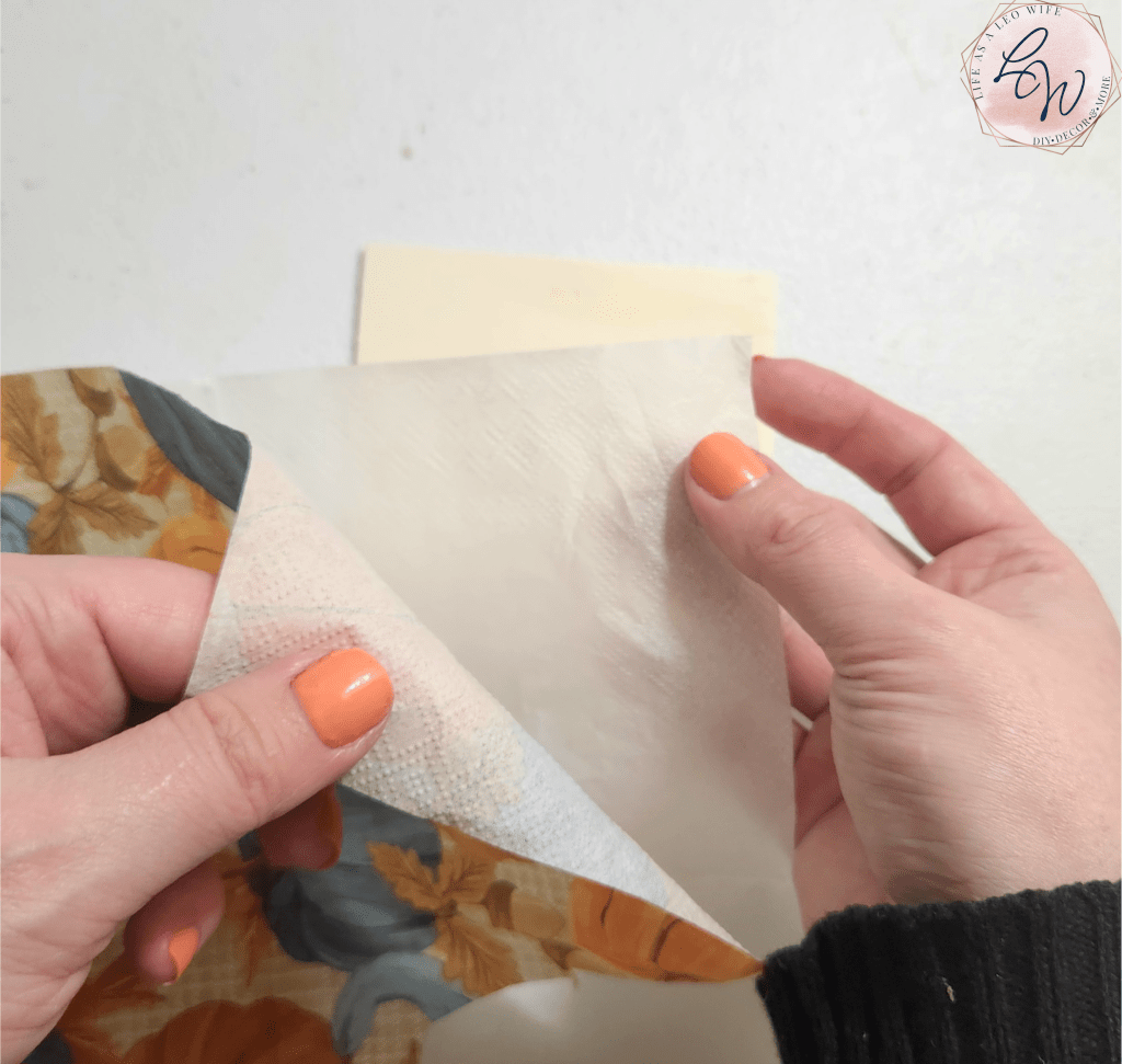Pulling the 2-ply layers of the fall pumpkin napkins apart to apply to the coasters.