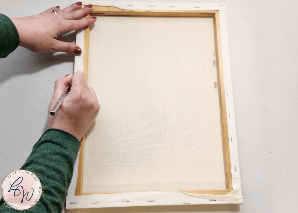Cutting the canvas off of the wood frame.