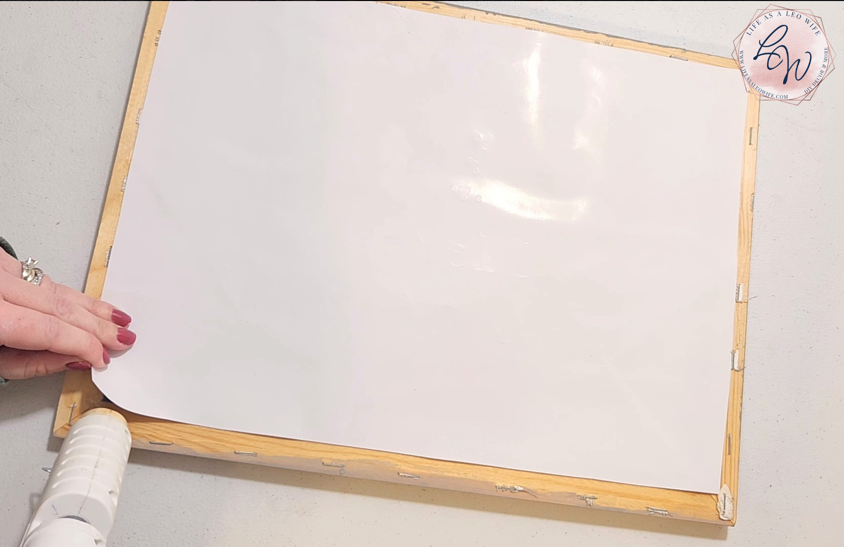 Gluing gift bag to the back of the canvas wood frame.