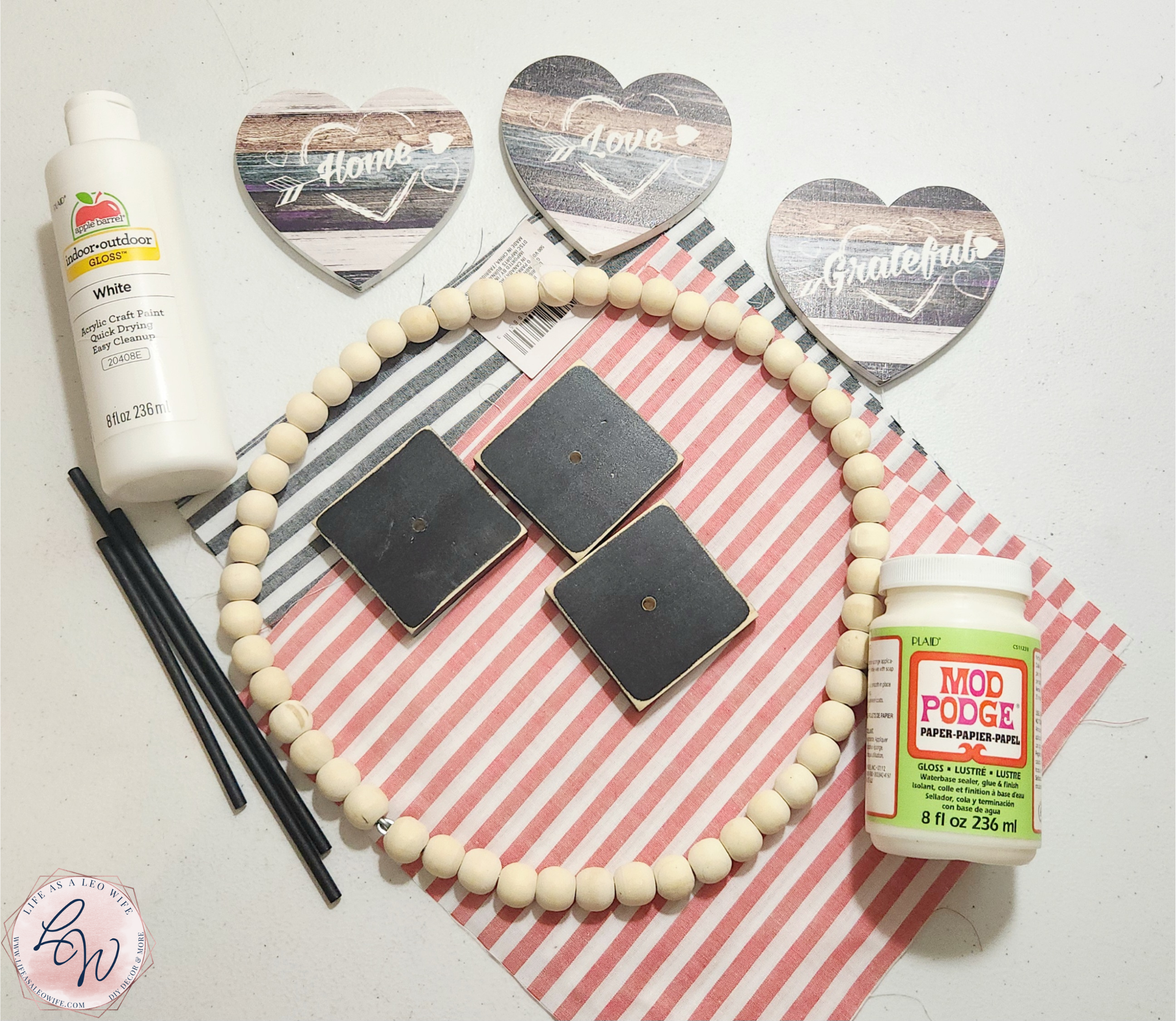 Supplies for the Valentine's Day wood bead heart shelf sitter decoration: wood bead wreath, wood hearts, wood blocks, and other items I didn't end up using.