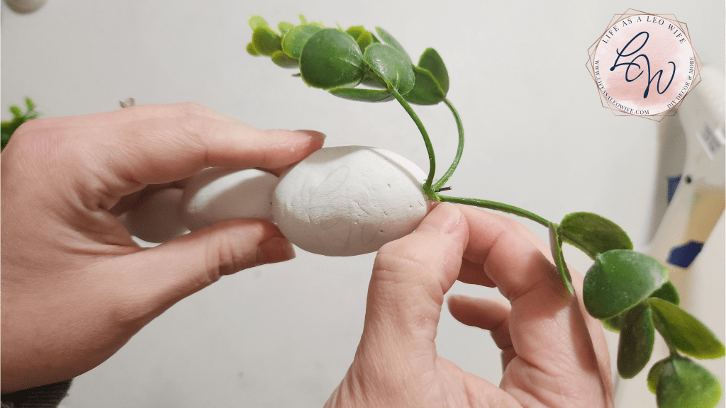 Eucalyptus branch pressed into the top of the Easter egg carrot while the glue dries.