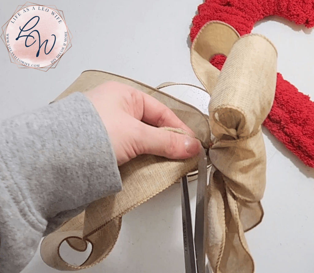 Cutting the excess ribbon off of the easy DIY bow.