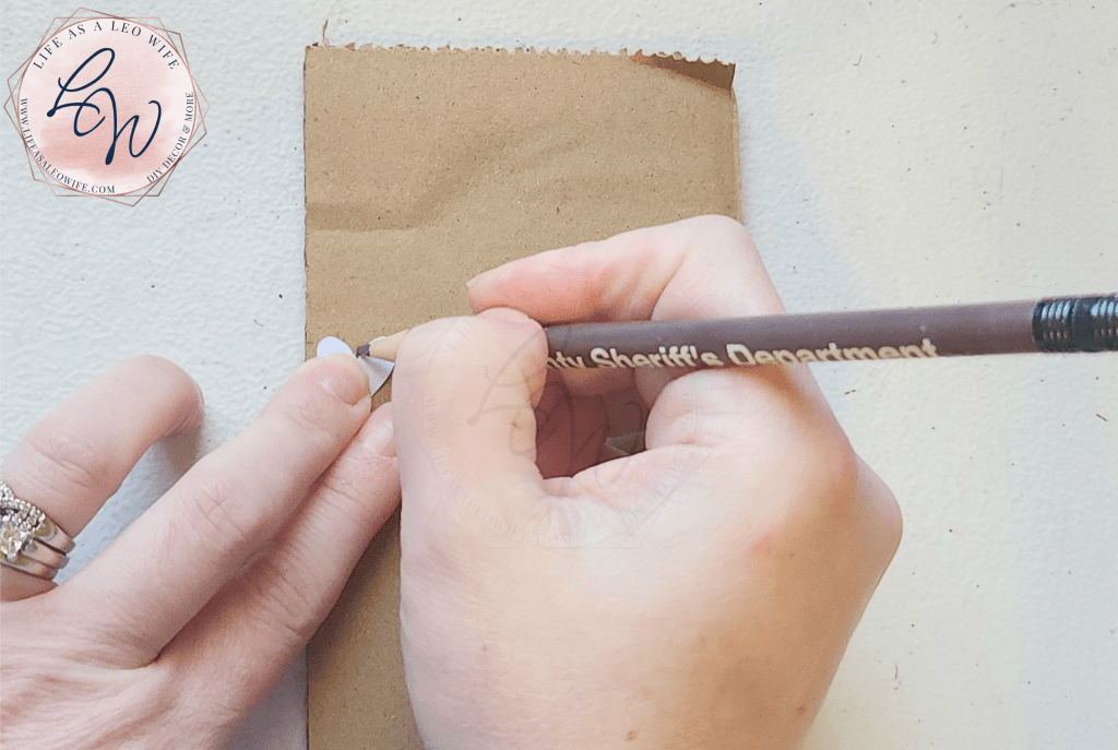 Tracing the paper heart onto cardboard.