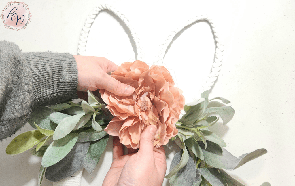 Adjusting flower in the center of the bunny wreath.
