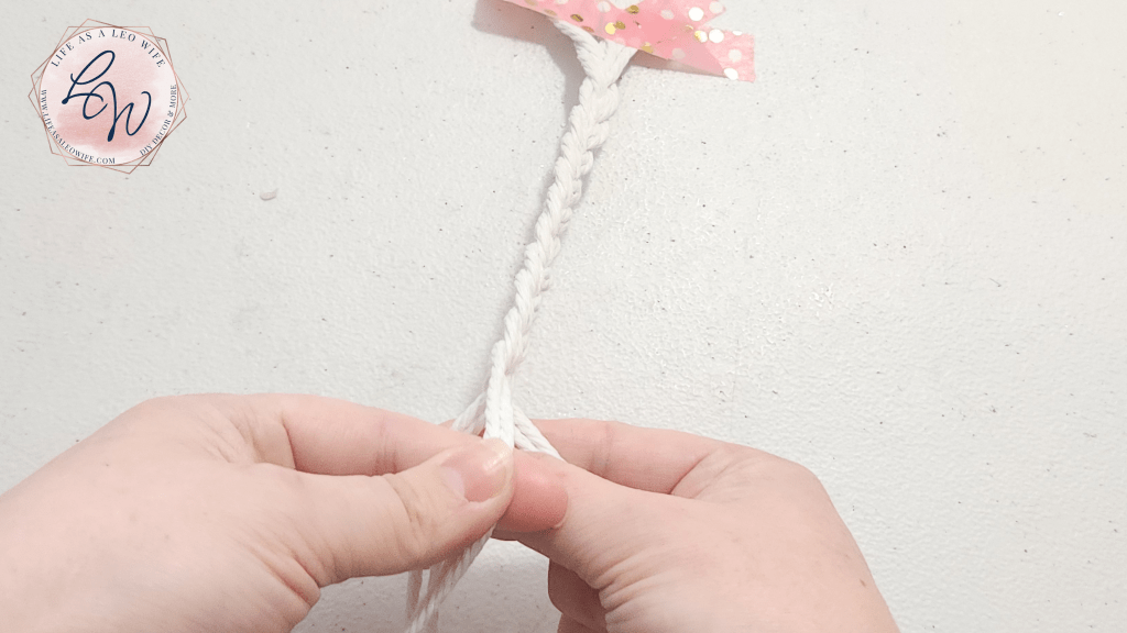 Braiding macrame cord; passing left cord over the center cord.