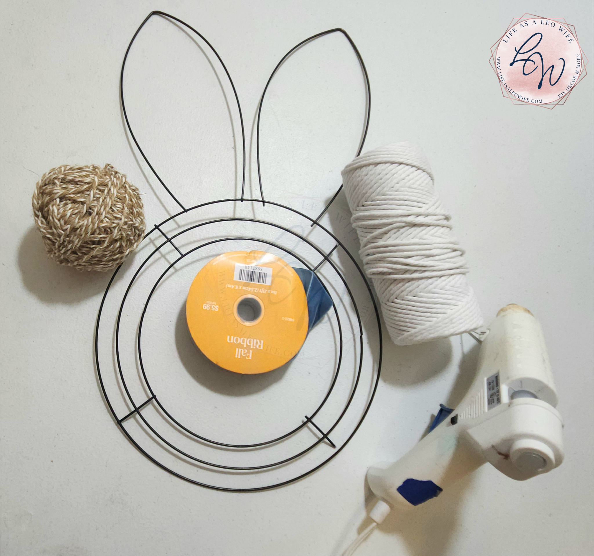 Supplies for bunny wreath: Dollar Tree bunny wreath frame, macrame cord, and a hot glue gun.
